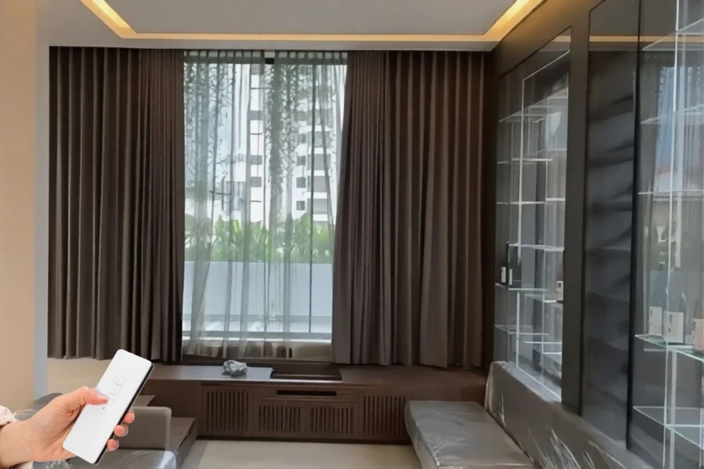 Smart motorized curtains in a Dubai bedroom featuring a sleek remote control.